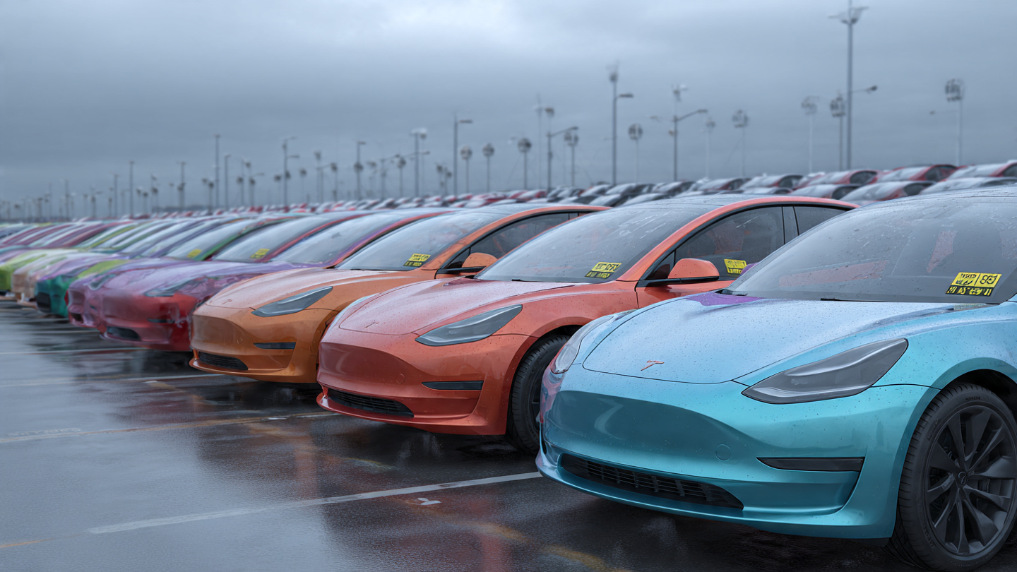 Row of used electric vehicles on a dealership lot under overcast sky with price stickers on windshields